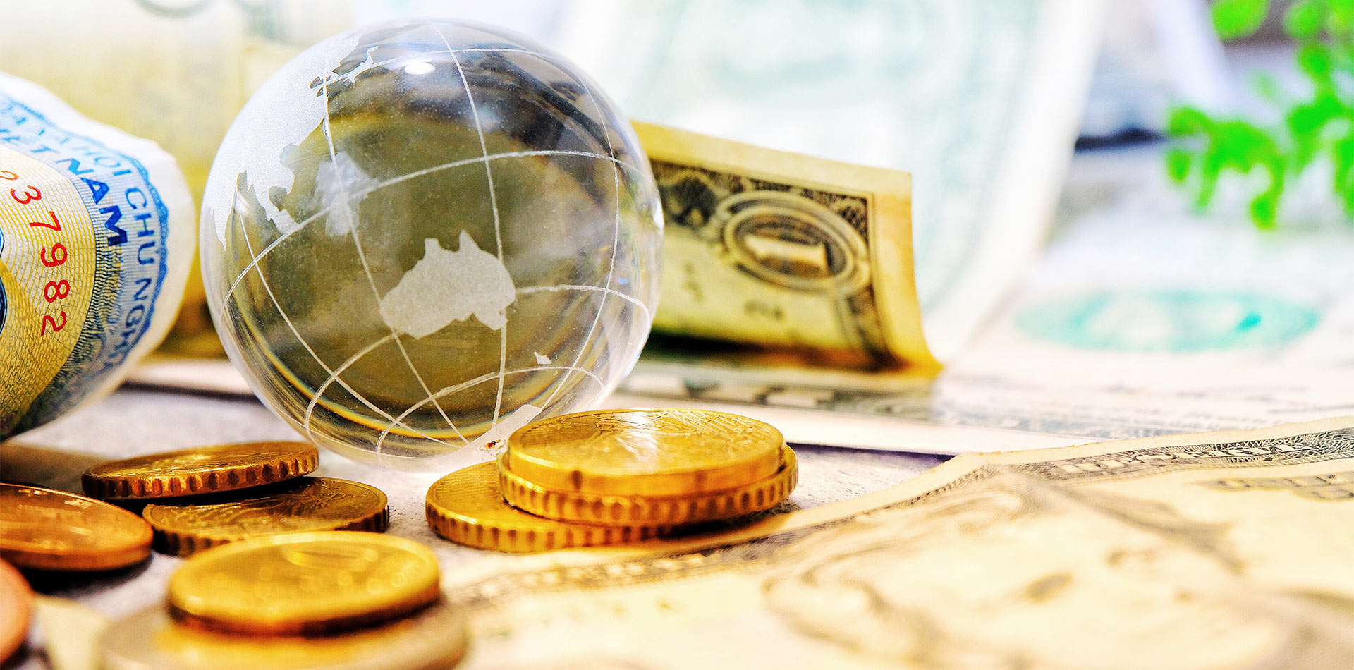 Globe with Australian currency and coins, symbolizing trade forex and global financial transactions.